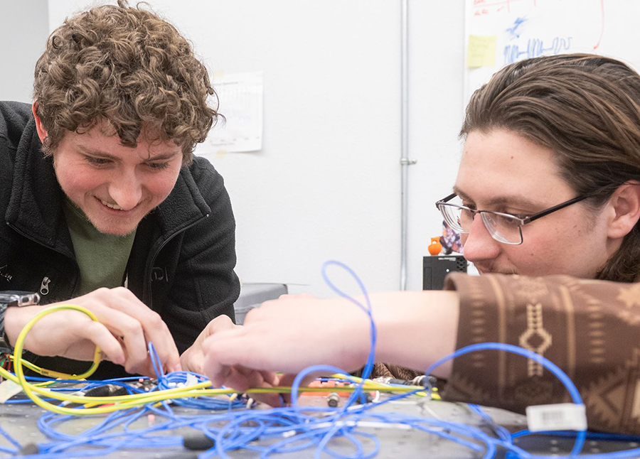 two male students working with blue wires