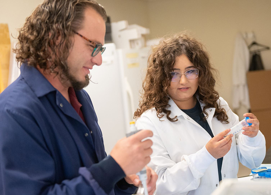 a male and female researcher working in a lab