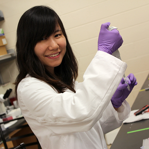A biology student works in her lab.