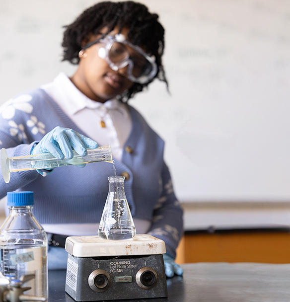 student measuring liquids