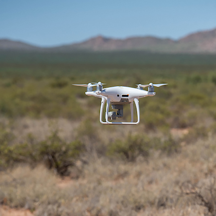 student using surveying instrument