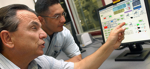 professors instructing student on a computer