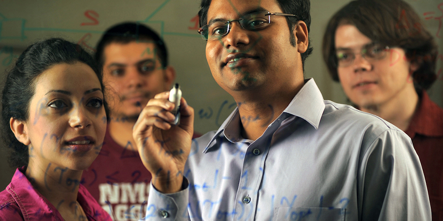 students making notes on dry-erase board
