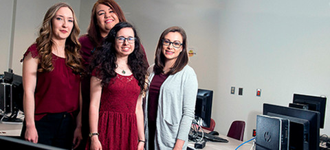 women standing by computers