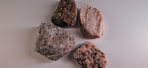 Four different rock samples sitting on a white background. 