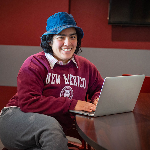 A female student working on a laptop.