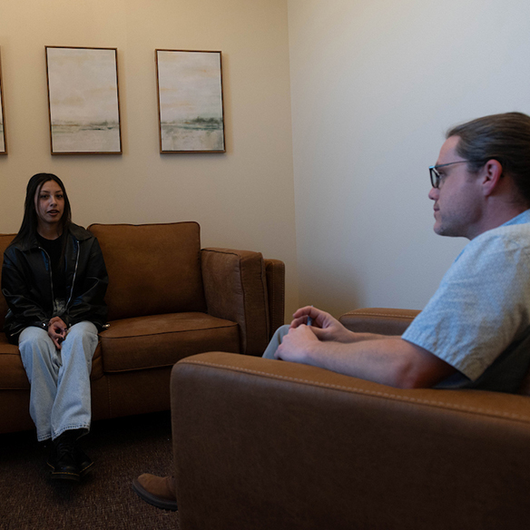 A school counselor speaking to a student. 