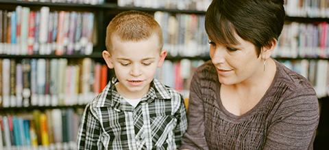 A stack of textbooks centered around counseling teens and children. 