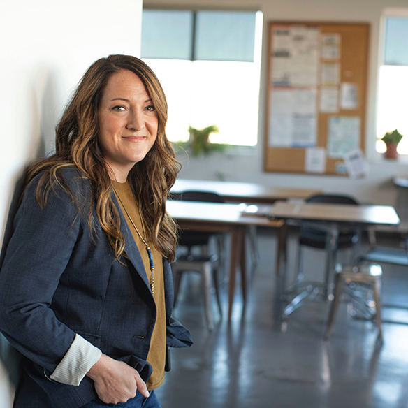 Woman standing in doorway of classroom