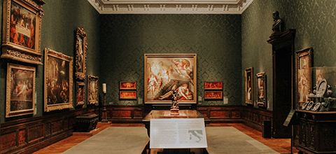 A room full of art in a museum. 