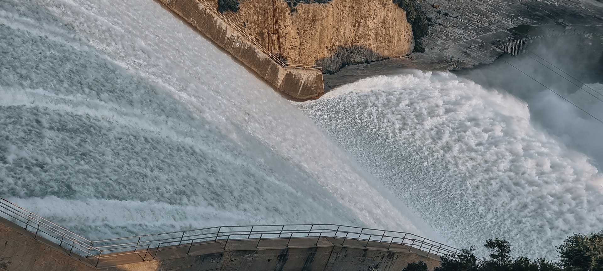water rushing down a dam causeway