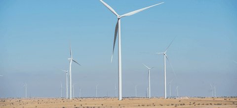 Large windmills spinning across the landscape.