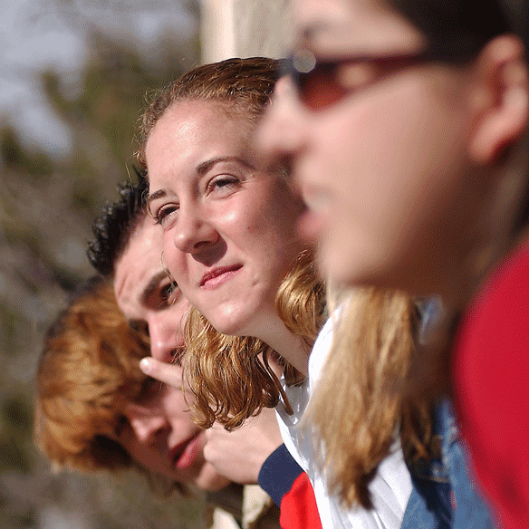 Students lined up looking over a balcony.