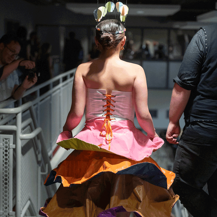 Student with fashion design items on a desk.