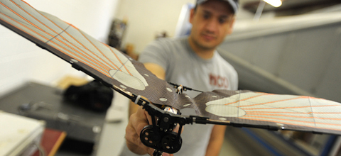 student showing a wind-tunnel instrument