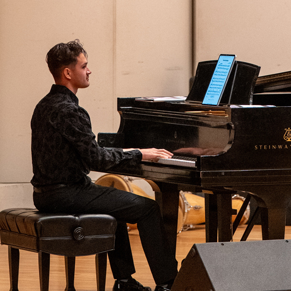 Pianist on stage reading music from an ipad