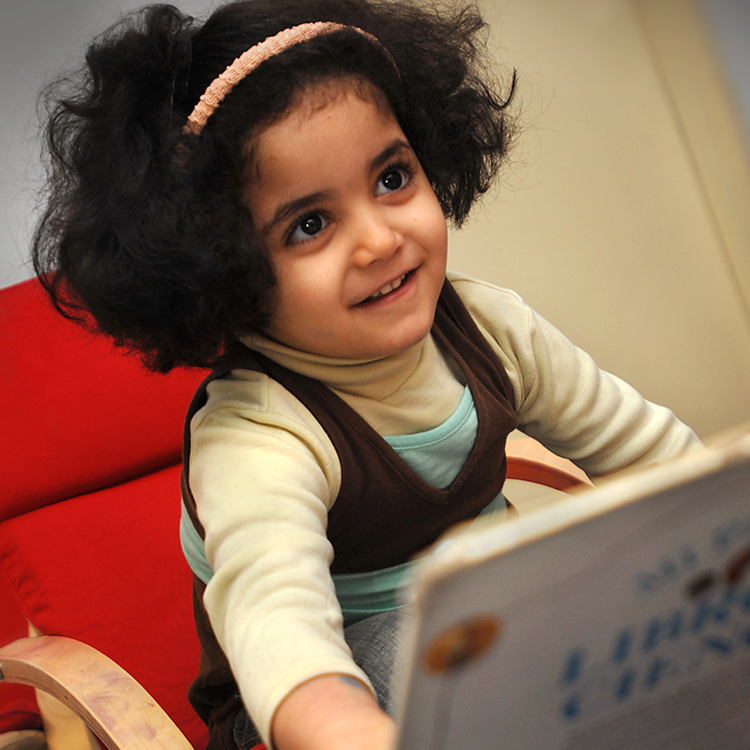 Young girl with teacher looking at computer