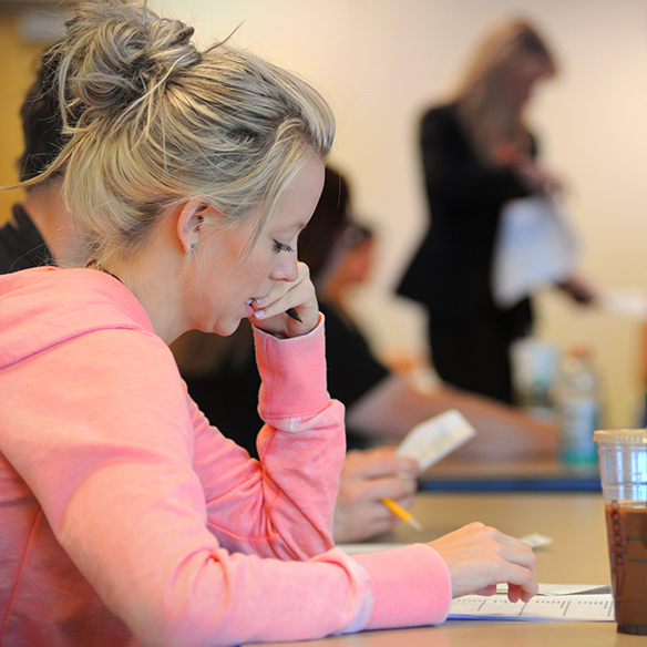 Girl completing paperwork at desk