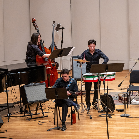 Performers on stage as part of the jazz ensamble