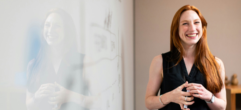 Woman standing at white board