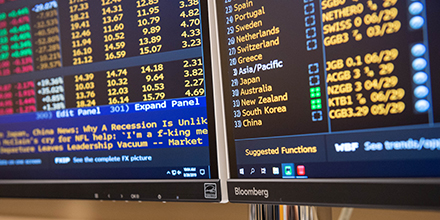 computer monitors showing financial dashboard