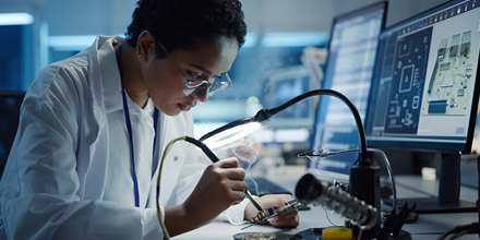 Engineering working on computer motherboard