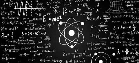 A chalkboard with various physics equations